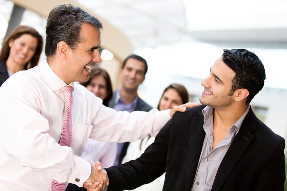 Business men closing deal with a handshake